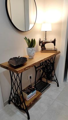 a table with a sewing machine on it and a potted plant next to it