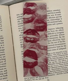 an open book with red and white images on the pages is shown in close up