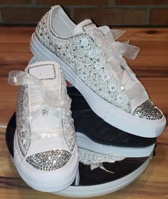 White low top Converse with bling toe and back and a beautiful bling and pearl shoe. All Converse shoes are 100% authentic from Converse or authorized retail sellers. Shoes are not returnable once they are customized. So please make sure you order the correct size. * Shoes can be made with different color crystals and different size if requested. * Allow two weeks for shoes to be shipped after purchase date. (shoes are normally done within one week and shipped) * No returns or exchanges But plea Wedding Tennis Shoes, Pearl Converse, Rhinestone Converse, Bedazzled Shoes Diy, Bride Sneakers, Wedding Shoes Sneakers, White Low Top Converse, Converse Wedding Shoes, Bedazzled Shoes