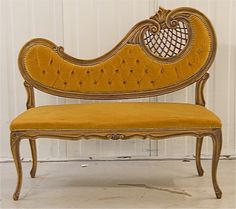 an old fashioned bench with yellow cushions