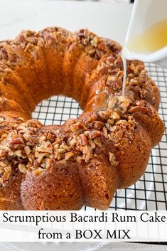 a bundt cake is being drizzled with icing on a cooling rack