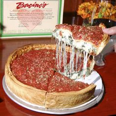 a deep dish pizza being served at a restaurant