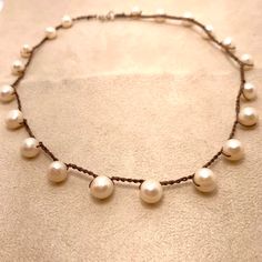 Fresh water pearls are crocheted into a delicate 10 inch with a sterling clasp. Featured is a necklace on beige silk with white fresh water pearls. However, this item is available for custom order for both choice of pearl and silk color. Choose from the following: Pearl Color choices: pink, white, peacock blue/iris, blue, silver/grey. Please note preferences in Notes at check out. Silk Color choices: White, black, dark brown, ballet pink, dark pink, beige, grey/silver, pale blue, dark blue, peridot, lilac, amethyst, red, coral, garnet, irish green, olive and amber. Indicate custom preferences at check out in Notes, otherwise item as shown will be sent. Pearls signify faith, charity and innocence. They are said to enhance personal integrity and focus one's attentions. Pearls symbolize purit Handmade Delicate Pearl White Pearl Necklace, Delicate Handmade Pearl White Necklace, White Round Pearl Necklace With Natural Stones, Adjustable White Pearl Necklace, Fresh Water Pearl Necklace, Earring Kit, Ballet Pink, Bronze Patina, Peacock Blue