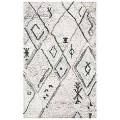 a white rug with black and blue designs on it's edges, in the shape of diamonds