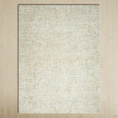 an empty white square frame hanging on a wall with wood paneling in the background