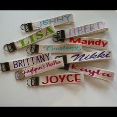 several name tags are attached to the side of a keychain