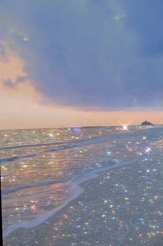 the sky is filled with stars and sparkles as seen from an airplane window at sunset