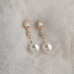 "* Pearl Gold Post Earrings, Wedding Jewelry for Brides, White Pearl Wedding Earrings, Pearl Gold Post Earrings, Wedding Earrings, Pearl Jewelry * Gold-filled wire wrapped crystal white pearl (10mm) and gold tone cubic zirconia teardrop 925 silver silver post. Earrings measure 1 1/4\". * Pearl Silver Post Earrings (shown in the 8th picture) ~ https://www.etsy.com/listing/755858542/wedding-jewelry-for-brides-white-pearl * TAKE 10% OFF $75 OR MORE WITH COUPON CODE ~ WEDDINGS10 * TAKE 15% OFF $100 Pearl Drop Dangle Clip-on Earrings For Wedding, Delicate Gold Earrings For Mother Of The Bride, Gold Drop Earrings As Wedding Gift, Gold Drop Earrings For Wedding Gift, Dainty Pearl White Bridal Earrings For Wedding, Pearl White Clip-on Earrings For Wedding, Elegant Gold Bridal Earrings For Wedding Gift, Elegant Jewelry For Marriage With Matching Earrings, Delicate Round Bridal Earrings For Wedding