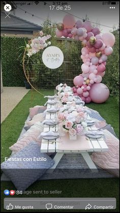 a table set up with balloons and flowers for an outdoor party or birthday celebration in the backyard