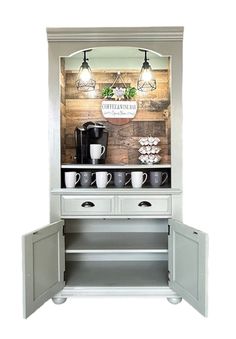 an open cabinet with coffee pots and cups on the shelves, in front of a white background