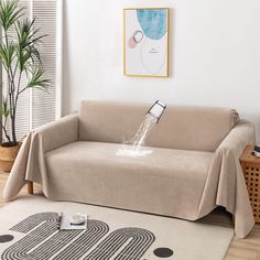 a couch covered with a blanket and water coming out of it