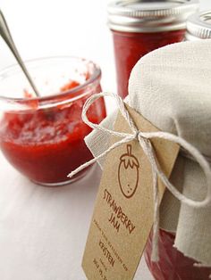 a jar of ketchup sitting on top of a table next to a napkin