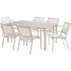 an outdoor dining table with white chairs