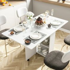 a white dining table set with place settings