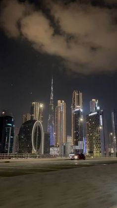 the city skyline is lit up at night