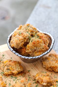 some food is in a metal bowl on a cutting board and ready to be eaten