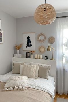 a bed with white sheets and pillows in a bedroom