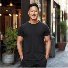 Featuring a strong Asian man wearing a black 3001 Bella Canvas T-shirt ! This mockup template is perfect for anyone in the Print-On-Demand (POD) industry or looking for a simple and stylish lifestyle mockup. With this digital download, you'll have access to high-quality images that'll be sure to make your shop stand out! Don't wait, add these beautiful mockups to your collection today! Available colors: Black Mockup Details: Brand: Bella Canvas Shirt: 3001 Classic Fit Sport Heavy Blend T-Shirt ATTN: Although most colors should match the mockups on Printify and Printful, there may be a few that are slightly off. If you encounter any issues with the color you want to use, please send me a message and I will work with you to find a solution. Size: Large Digital Download: This is an instant do Black Relaxed Fit T-shirt For Sports, Short Sleeve Workout T-shirt, Workout T-shirt With Short Sleeves, Solid Color Short Sleeve Workout T-shirt, Basic Crew Neck Moisture-wicking T-shirt, Black Pre-shrunk Short Sleeve Activewear, Moisture-wicking Basic Crew Neck T-shirt, Solid Color Short Sleeve Gym T-shirt, Black Cotton Short Sleeve Activewear