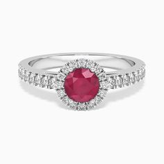 Description Radiate sophistication with our Round Cut Halo Ring crafted in sterling silver, featuring a stunning ruby gemstone. The round-cut ruby is embraced by a halo of sterling silver, exuding timeless elegance and luxury with every glance.on. Specifications Made in 925 Sterling Silver Gender: Women Material: Rhodium Plated Sterling Silver Weight:2.4 gm GEMSTONE MAIN Gemstone: Round Cut Natural Ruby Setting : 4 Claw Gemstone Colour: Red Gemstone Dimensions:5 mm Gemstone Type: Natural Ruby -T Luxury Timeless Round Birthstone Ring, Luxury Silver Birthstone Ring With Halo Setting, Luxury Silver Ruby Ring With Halo Setting, Luxury Sterling Silver Ruby Ring With Round Cut, Round Halo Ring, Round Halo, Round Engagement Rings, Timeless Luxury, Red Gemstones