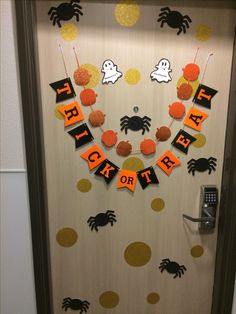 a door decorated for halloween with orange and black decorations