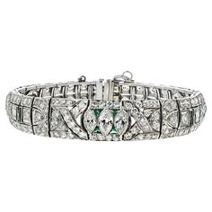 Immerse yourself in the timeless elegance of the Platinum Art Deco Diamond and Emerald Bracelet. This exquisite piece is a testament to the opulence and craftsmanship of the Art Deco era, showcasing a stunning combination of diamonds and emeralds. Featuring an impressive 8.50 carats total weight of various cut diamonds, this bracelet sparkles with unmatched brilliance. The diamonds are meticulously set in a sophisticated platinum design, enhancing their natural beauty and fire. Complementing the diamonds are vibrant green emeralds, adding a touch of color and luxury that epitomizes the Art Deco style. Green Emerald Bracelet, Emerald Bracelets, Platinum Bracelet, Modern Bracelets, Art Deco Bracelet, Emerald Bracelet, Baguette Cut Diamond, Estilo Art Deco, Emerald Stone