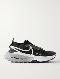 a black and white sneaker with the word zoom on it's upper part