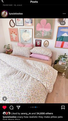 a bed with pink and white comforter in a bedroom next to pictures on the wall