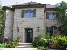 a large stone house with lots of windows