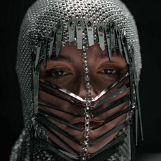 a woman with spikes and chains on her face