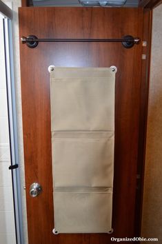 an open door with a towel hanging on the front and side bars attached to it