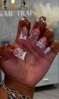 a person holding up their hand with some nail art on it's fingers and nails