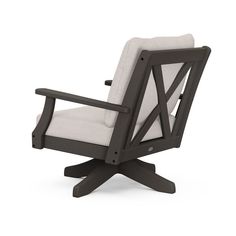 a chair that is sitting on top of a white surface with a black frame and armrest