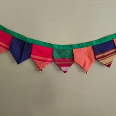 an assortment of colorful ties hanging on a wall