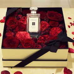 a box filled with red roses on top of a table