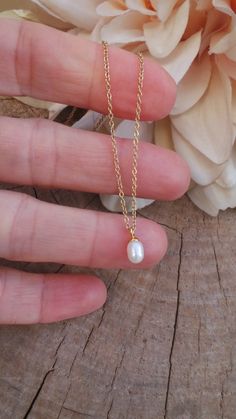 This delicate necklace is just perfect to wear on its own or layered with your favourite pieces! Pearls are also the birthstone of anyone born in the month of June. D E T A I L S *It features a single AA grade cultured white teardrop pearl. These measure between 4 and 5mm and have a smooth, even nacre. *It is suspended from a super dainty  stainless steel chain. Chain is available in 14k gold, rose gold and silver. *Stainless steel is very hard wearing and will not tarnish or oxidise. It is also amazingly hypoallergenic. *Necklace comes with a crystal information card and is ready for gifting. S I Z I N G * H E L P To ensure you get the right size measure your neck with a piece of string where you would like your necklace to sit. Then with a ruler or measuring tape measure your string. Thi Dainty Pearl Pendant Necklace With Delicate Chain, Pearl Chain Drop Necklace With Teardrop Pendant For Gift, Pear-shaped Drop Necklace With Pearl Chain For Gift, Dainty White Drop Necklace For Gifts, Delicate Pearl Chain Necklace With Teardrop Pendant, Teardrop Pearl Necklace For Everyday, Pearl Teardrop Necklace For Everyday, Rose Gold Teardrop Necklace With Pearl Pendant, Pearl Charm Teardrop Pendant Drop Necklace Gift