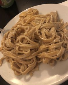 a white plate topped with pasta and sauce