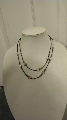 This is a Lia Sophia "Daybreak"  grey mother-of-pearl and freshwater pearl and black seed bead two-strand necklace. The inner strand is 16.5 inches (41.91 cm) but can be extended to 19.5 inches (49.53 cm). It has a lobster claw clasp. If you or the intended recipient has a disability that makes using clasps difficult, I can attach an easier-to-use magnetic clasp, no extra charge. Lia Sophia was in business from 1986-2015. Please note that the final image was taken with flash, and the rest were n Handmade Adjustable Double Strand Pearl Necklace, Adjustable Silver Double Strand Pearl Necklace, Adjustable Silver Beaded Shell Necklace, Ultrasonic Jewelry Cleaner, Orion's Belt, Mother Of Pearl Jewelry, String Of Pearls, Black Seed, Lia Sophia