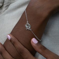 See more Bracelets! https://www.etsy.com/uk/shop/LilyCharmed?ref=seller-platform-mcnav&section_id=17722071 A contemporary sterling silver lotus flower bracelet on a fine chain, makes the perfectly peaceful gift for yourself or a family member. The lotus flower in Buddhist symbolism reflects of purity of the body, speech, and mind. Made From: Recycled 925 Sterling Silver  Dimensions: Lotus Charm 15x10mm Bracelet: 17.5cm with an extension chain to 20cm We are all looking for ways, big and small, t Buddhist Symbolism, Planet Necklace, Zodiac Pendant, The Lotus, Recycled Silver, Engraved Necklace, Flower Bracelet, Dream Jewelry, Matching Necklaces