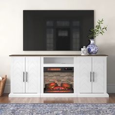 an entertainment center with a flat screen tv and fireplace