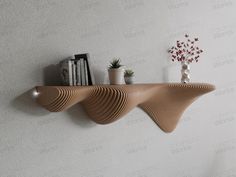 a shelf with books and vases on it next to a wall mounted bookcase