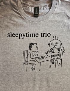 SLEEPYTIME TRIO t-shirt Hand screenprinted on Gildan Premium / 'Midweight Softstyle' 100% ringspun cotton t-shirts. Inks are non-toxic and can be machine washed/dried.. White print on black shirt, or black print on gray, white, red or yellow shirt. The same print is available on  Crewneck sweatshirts: https://www.etsy.com/uk/Bundschuhconspiracy/listing/654395687/ Pullover hoodies: https://www.etsy.com/uk/Bundschuhconspiracy/listing/640563092/ Patches: https://www.etsy.com/uk/listing/223382310/ Short Sleeve Graphic Print Sleep T-shirt, Short Sleeve Sleep T-shirt With Graphic Print, Emo Band, Yellow Shirt, Emo Bands, Yellow Shirts, Pullover Hoodies, Black Print, Gray White