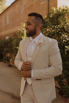 a man in a suit and tie standing outside