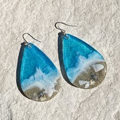 These realistic beach earrings are made with layers of shimmering translucent resin, real sand and bright colorful inks with a silver plated sea turtle. They are available in 2 sizes. These are made to order and yours may be slightly different than those pictured. White Resin Earrings For The Beach, Resin Drop Earrings For Beach, Nickel-free Teardrop Earrings For Beach, Silver Teardrop Earrings For Beach, Nickel-free Teardrop Jewelry For Beach, Resin Earrings For Summer Beach, Summer Beach Resin Earrings, Resin Dangle Earrings For Beach, Summer Beach Teardrop Earrings