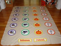 a table covered in halloween themed stickers on top of a hard wood floor next to a white door