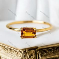 Emerald Cut Citrine Ring Vintage Style Gemstone Ring Yellow Gold Engagement Ring November Birthstone Jewelry Minimalist Jewelry Promise Gift Description: - Main Stone - Citrine Stone Creation - Lab Created  Stone Shape - Emerald Cut Stone Color - Yellow  Stone Size - 7 x 5 MM We Gladly Accept Customized Orders And Please Do Contact Us For Any Further Queries Regarding Your Order,  Feel Free To Contact Us 24 x 7 Customer Support Available  Rush Orders Available Gold Citrine Crystal Open Ring, Minimalist Citrine Jewelry, Citrine Crystal Promise Ring, Fine Jewelry Citrine Crystal Ring, Gold Minimalist Topaz Promise Ring, Minimalist Citrine Promise Ring, Minimalist Topaz Rings As Gifts, Minimalist Citrine Birthstone Rings, Minimalist Amber Ring Jewelry