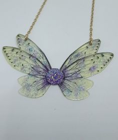 Discover the new magnificent collection of resin fairy wing necklaces. They have been created with love to add a magical and magical touch to your day! *The fairy wing necklace was created by me in my magical workshop. The necklace has a stainless steel chain adjustable by an extension chain. These high-end jewelry pieces are both elegant and durable. *The magical and magical fairy wings are made from resin which is a delicate but sturdy material once hardens. A certain light and shine has been Unique Party Necklaces, Whimsical Resin Jewelry For Party, Fairy Style Handmade Jewelry For Parties, Iridescent Fairy Style Jewelry For Party, Handmade Fairy Style Jewelry For Parties, Fairy Grunge Handmade Necklace For Party, Handmade Fairycore Necklaces For Party, Handmade Fairy Grunge Necklaces For Party, Fairy Grunge Handmade Party Necklaces