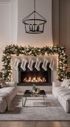 a living room decorated for christmas with stockings hung over the fireplace