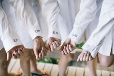 a group of people holding their hands together