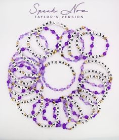 six bracelets with words written on them and beaded in gold, purple and white beads