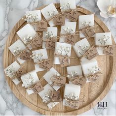 a wooden platter filled with lots of white soaps